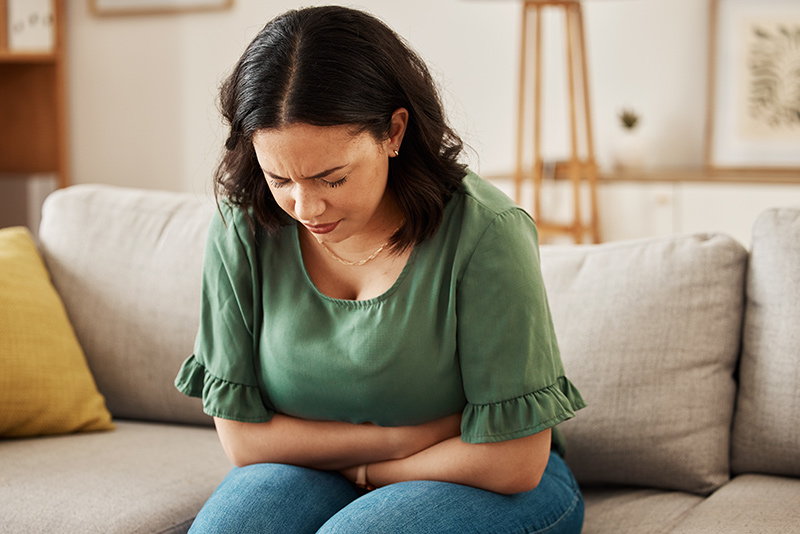 A woman experiencing abdominal discomfort