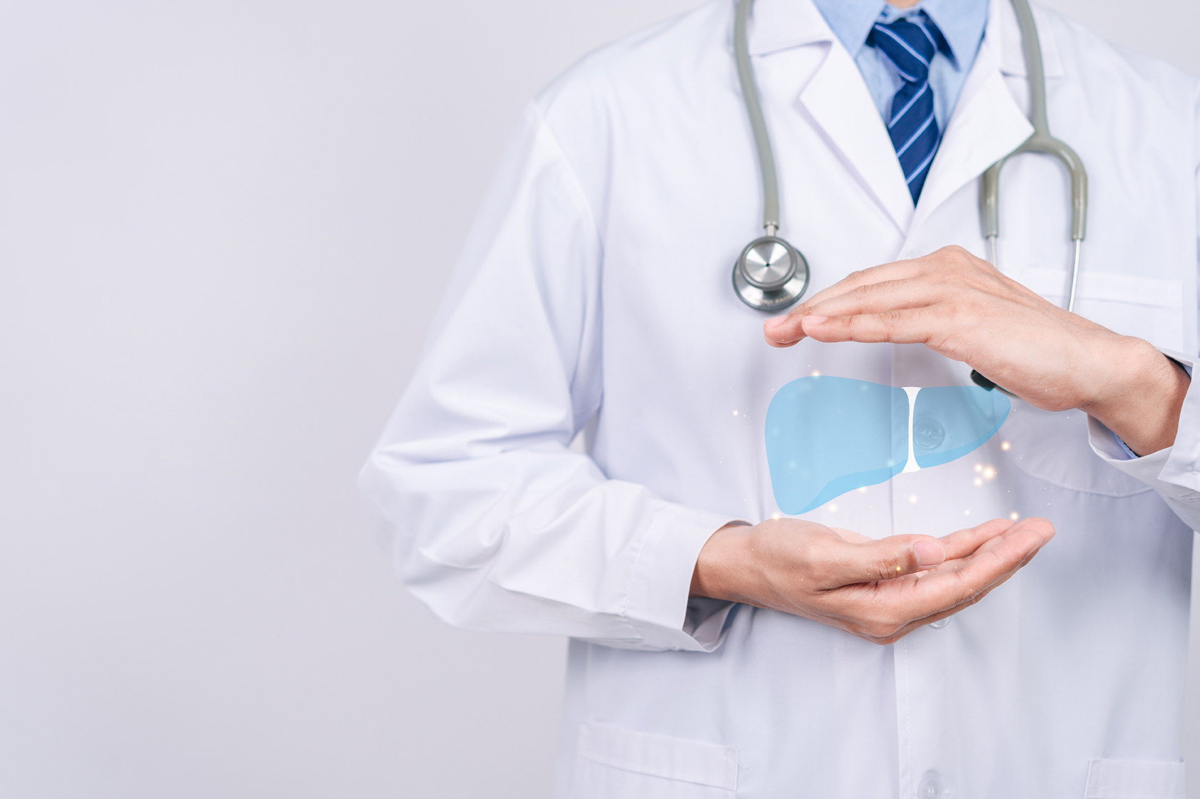 A doctor holding an image of a liver