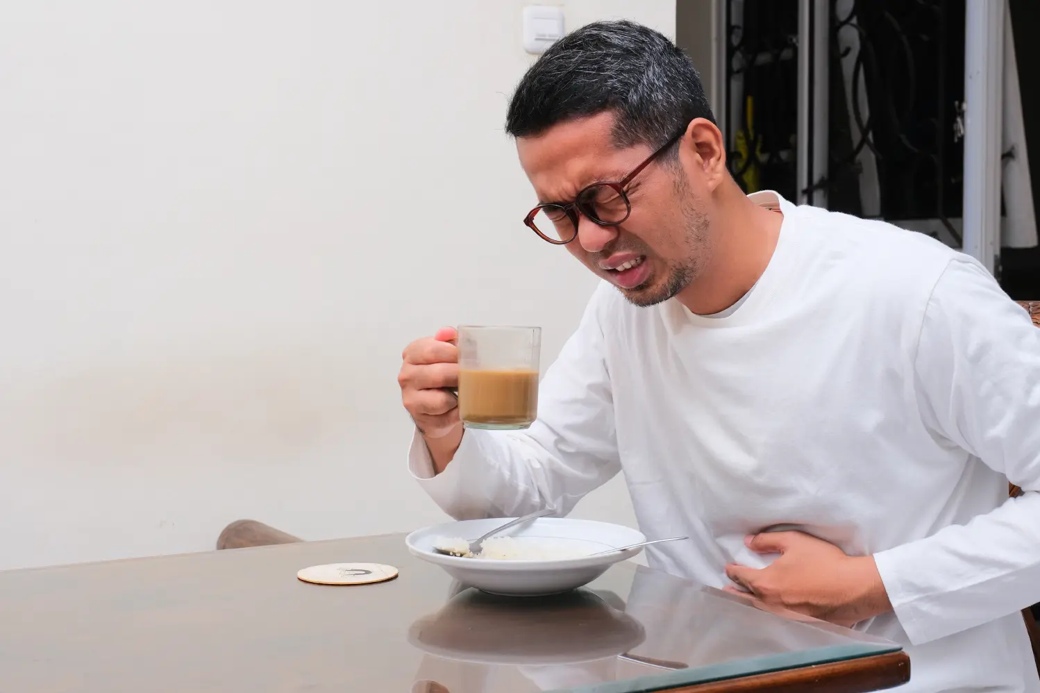 Man experiencing heartburn, a common symptom of acid reflux (GERD)