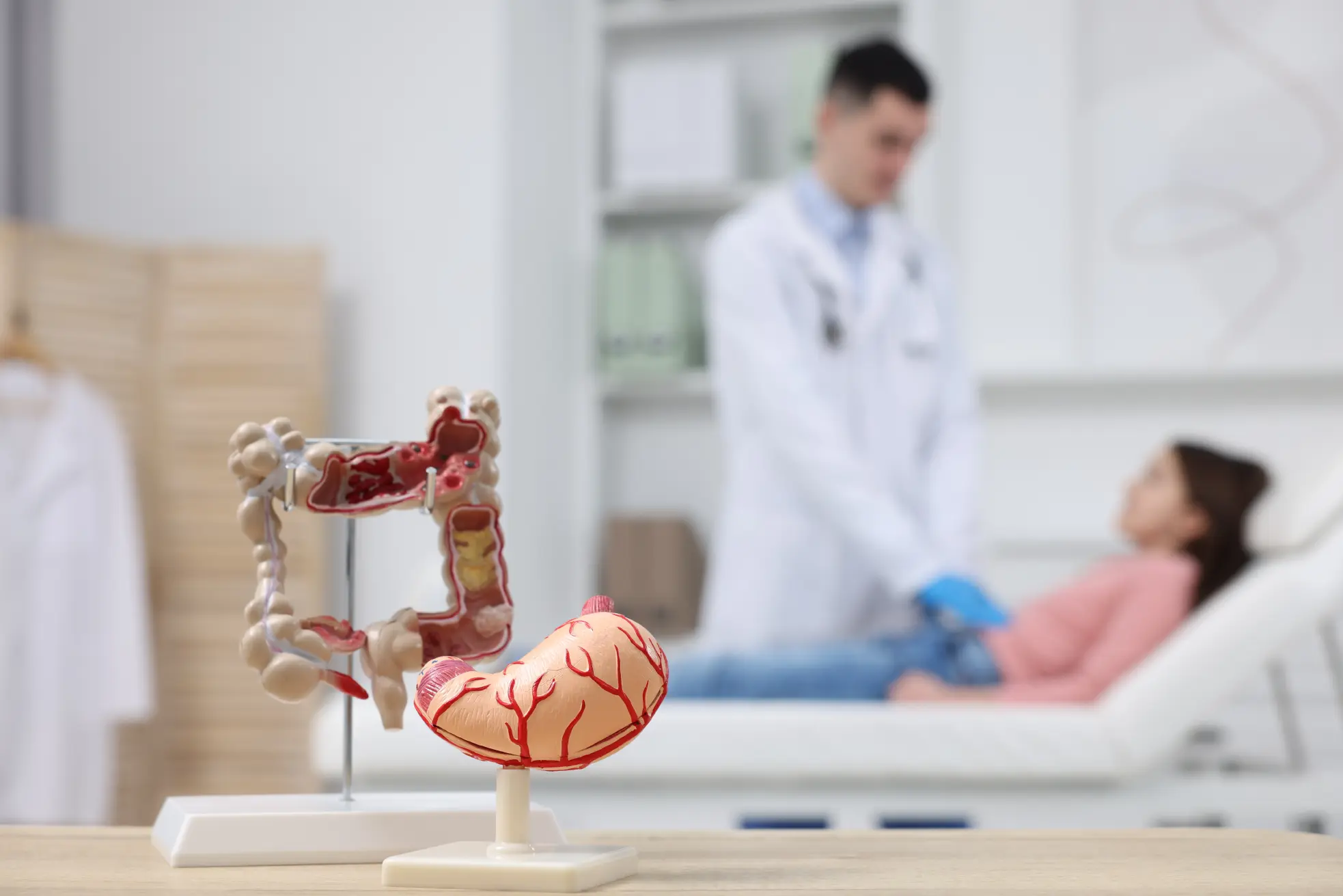 Gastroenterologist assessing a patient during a consultation for digestive symptoms