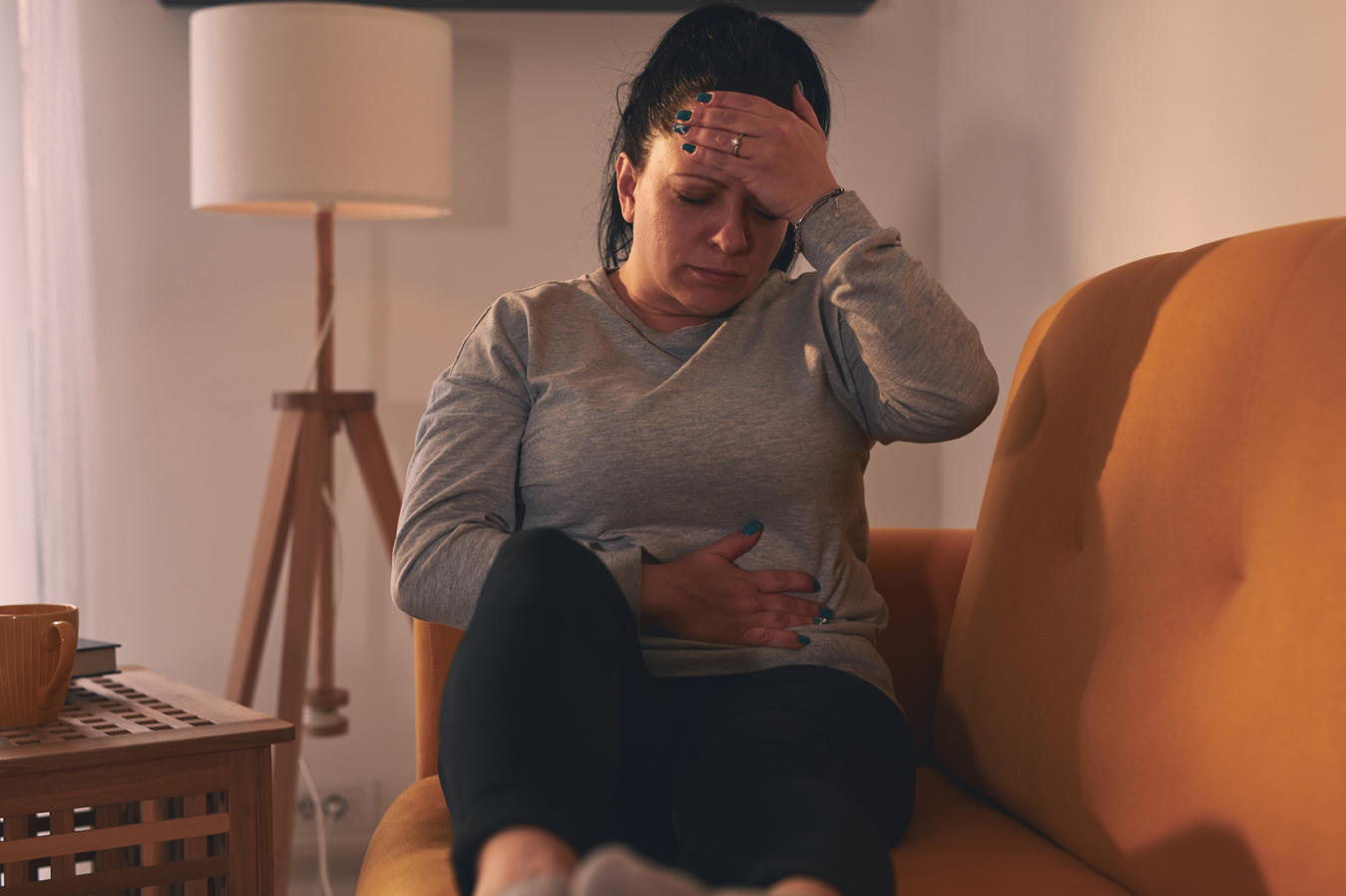 A woman experiencing nausea and stomach discomfort