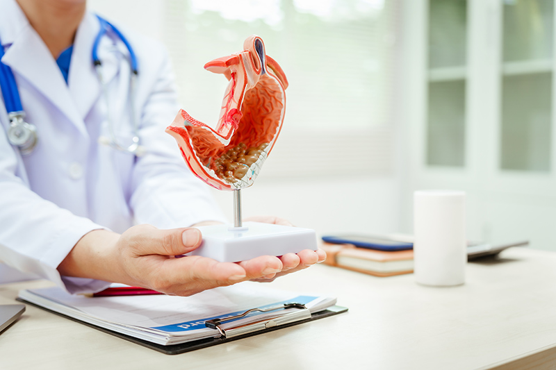 A doctor explaining gastritis treatment to a patient during a consultation